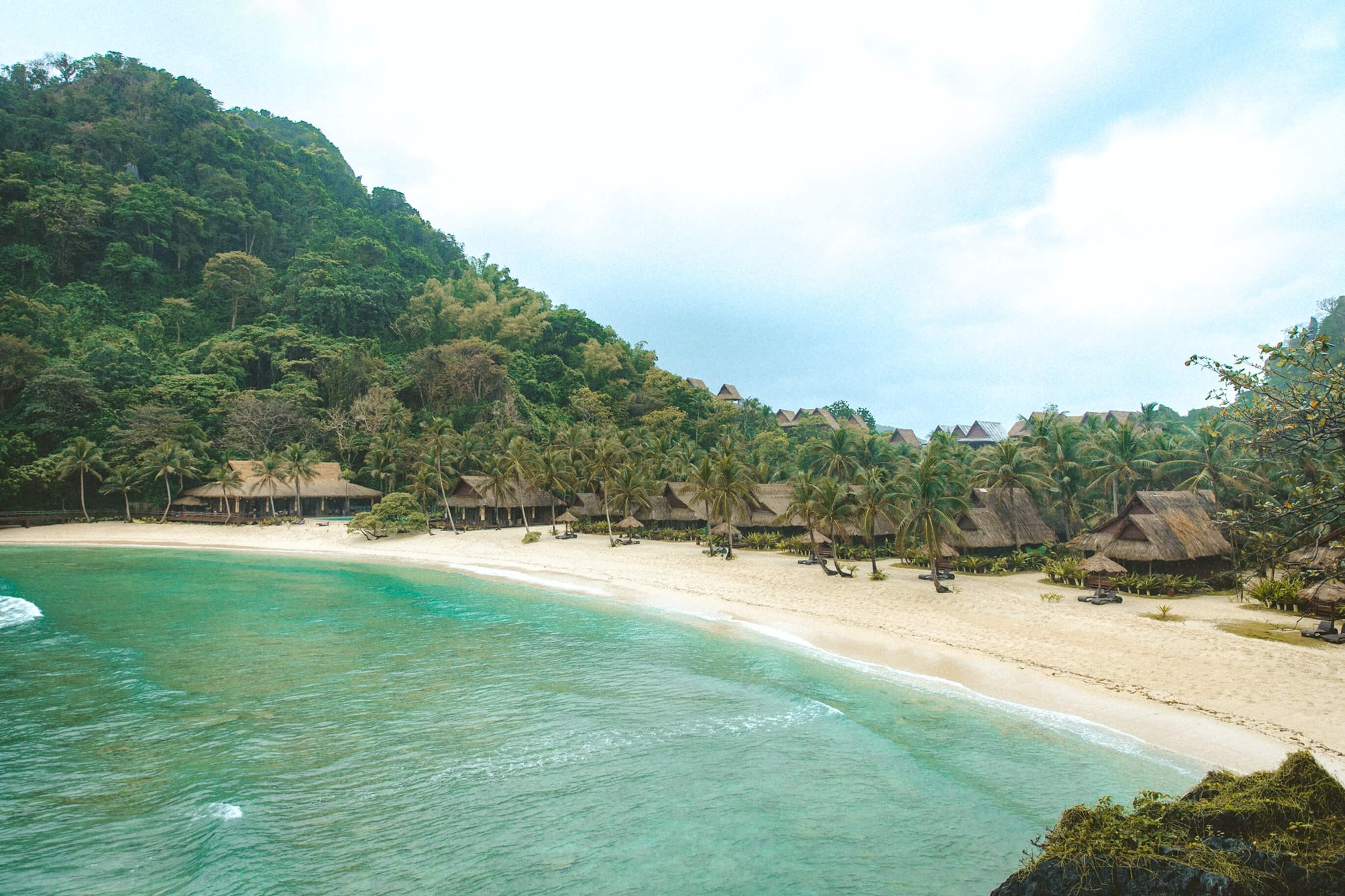 Tropical paradise beach surrounded by lush greenery, showcasing the work of the best digital experience agencies UK.