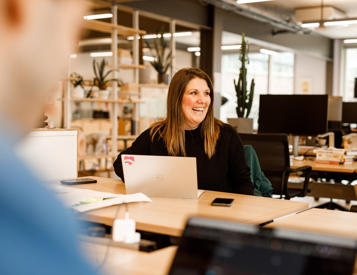 Top web development agency UK office environment with team in discussion.