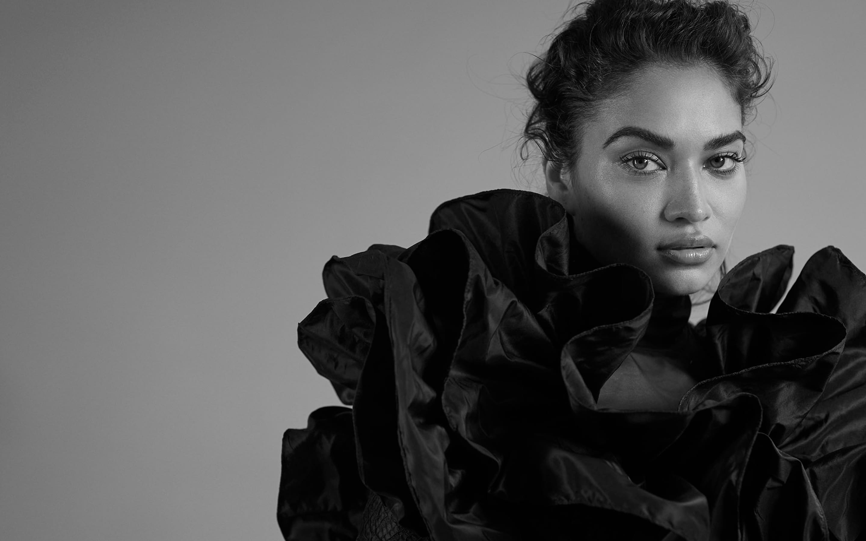 Black and white portrait of a person wearing a ruffled, textured outfit, representing the best web design agencies in London.